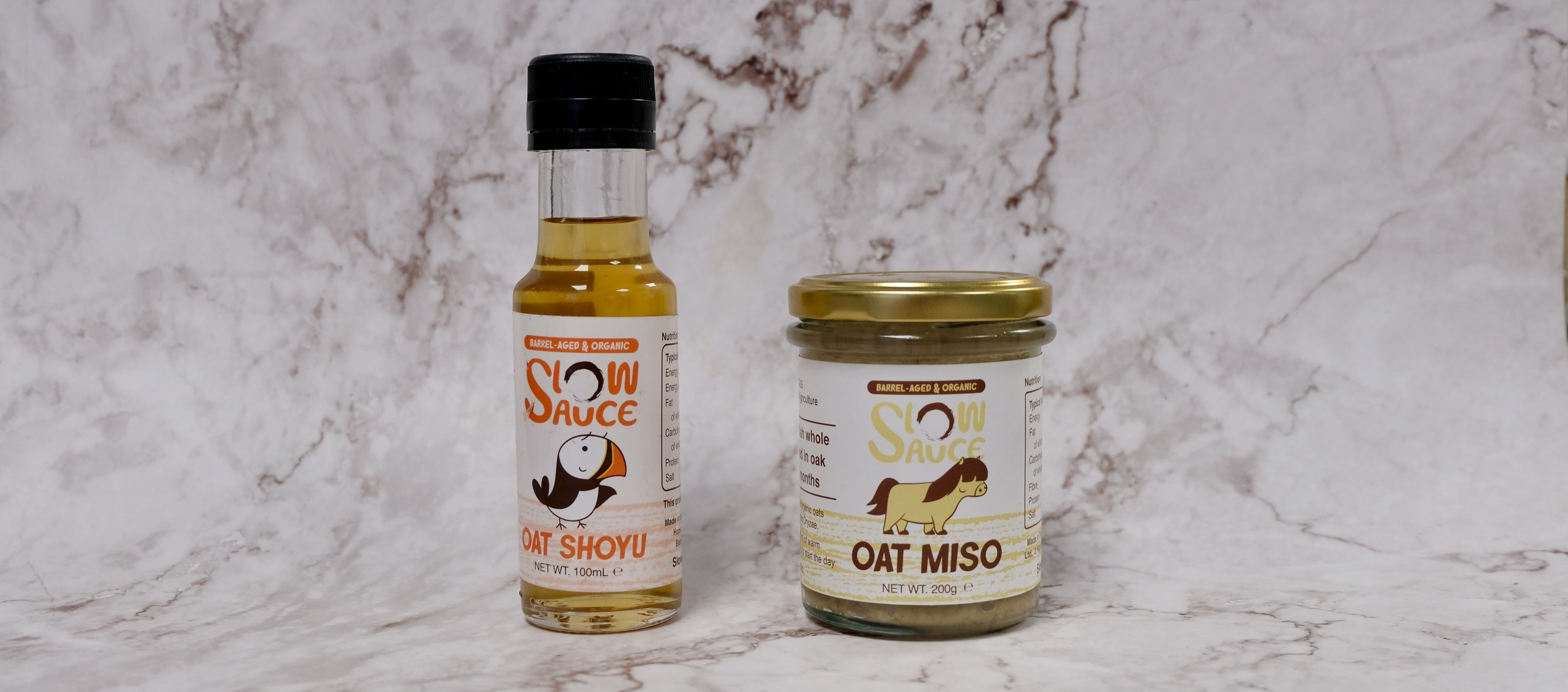 Bottle of Slow Sauce Oat Shoyu and jar of Slow Sauce Oat Miso on a marble background – small-batch Scottish fermented sauces